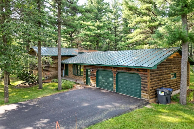 exterior space featuring a garage and a front lawn