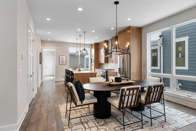 dining space with hardwood / wood-style floors, visible vents, recessed lighting, and baseboards