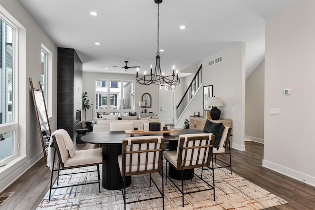 dining room featuring baseboards, stairway, recessed lighting, an inviting chandelier, and wood finished floors