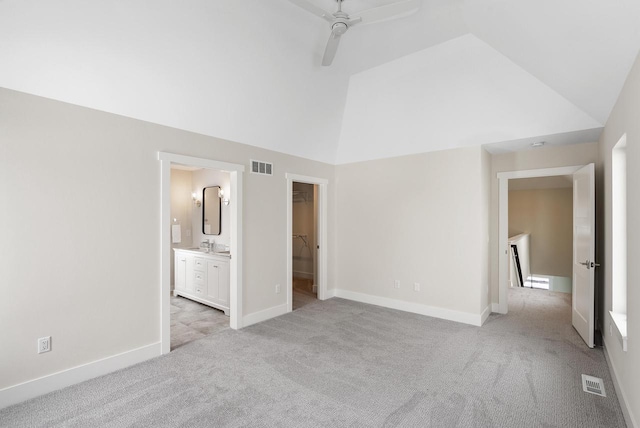 unfurnished bedroom with light carpet, visible vents, a spacious closet, and baseboards