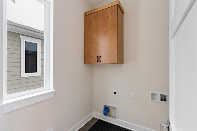 clothes washing area featuring baseboards, cabinet space, hookup for an electric dryer, and washer hookup