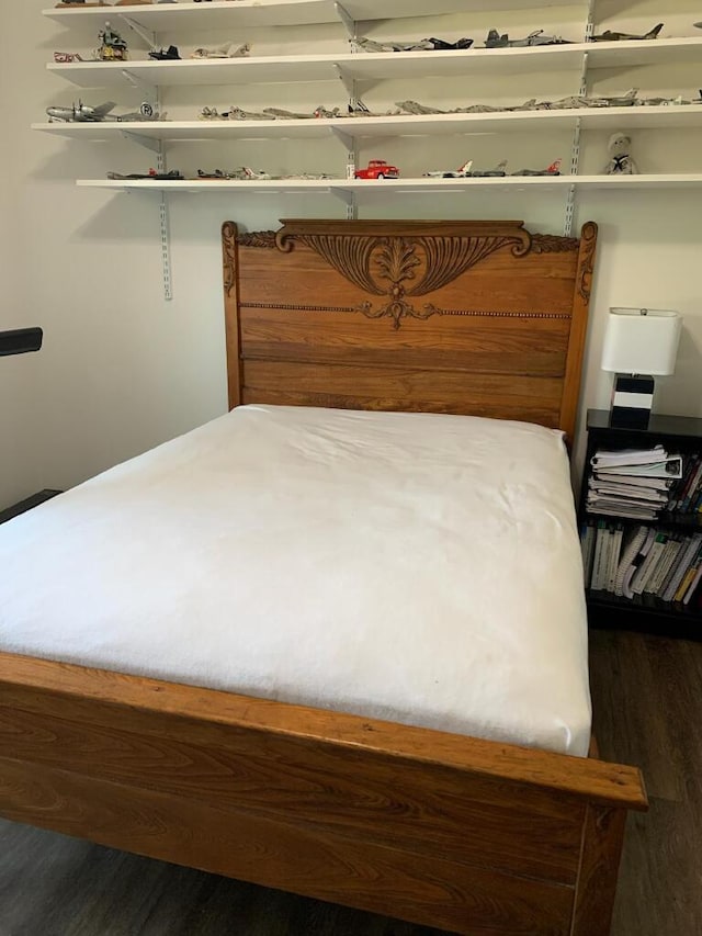 bedroom with dark hardwood / wood-style flooring