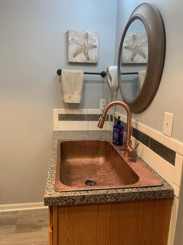 bathroom with vanity and hardwood / wood-style floors