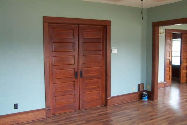 unfurnished room with dark hardwood / wood-style floors