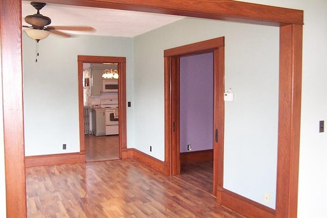 unfurnished room featuring hardwood / wood-style flooring and ceiling fan