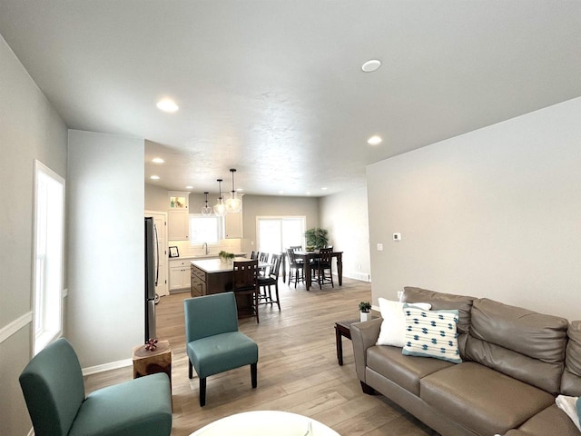 living room with sink and light hardwood / wood-style floors