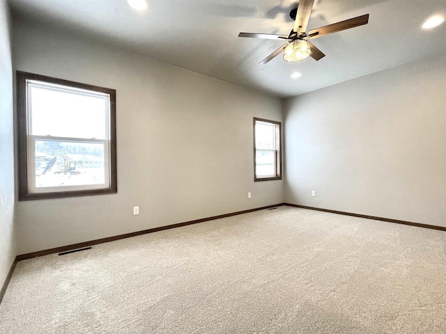 empty room featuring ceiling fan and carpet floors