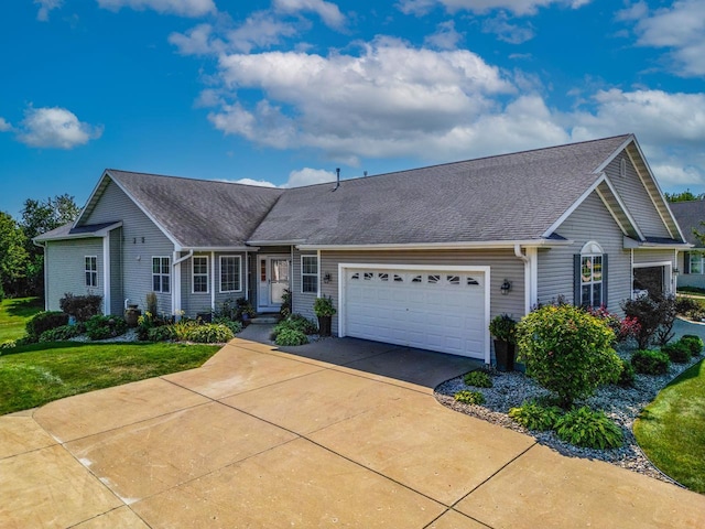 single story home with a garage, concrete driveway, a front lawn, and a shingled roof