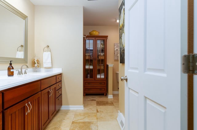 bathroom featuring visible vents, vanity, and baseboards