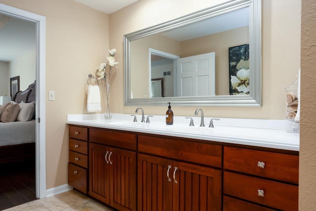 full bathroom with double vanity, visible vents, a sink, and ensuite bathroom