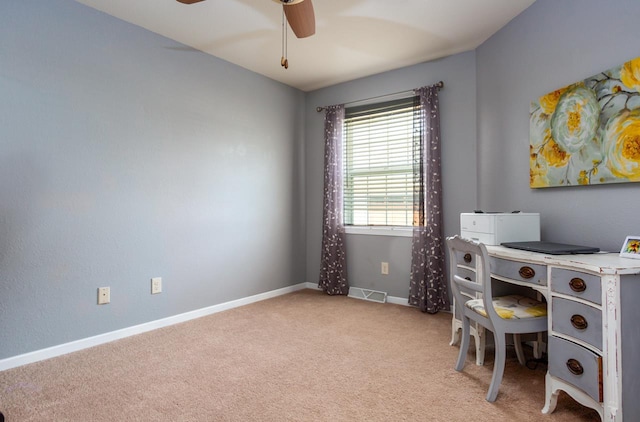 office featuring a ceiling fan, visible vents, light carpet, and baseboards