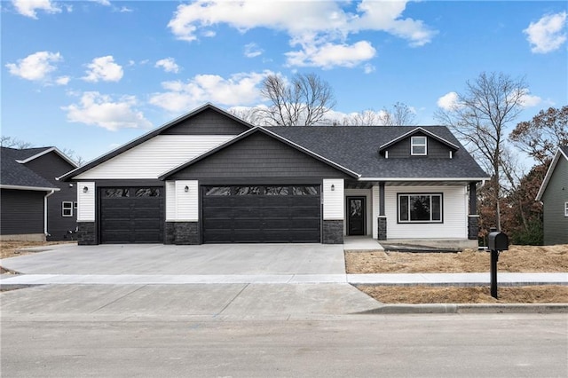 view of front of home featuring stone siding, concrete driveway, and an attached garage