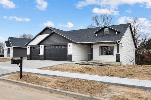 view of front of property with a garage, concrete driveway, and roof with shingles