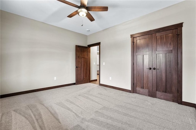 unfurnished bedroom featuring ceiling fan, carpet floors, and baseboards