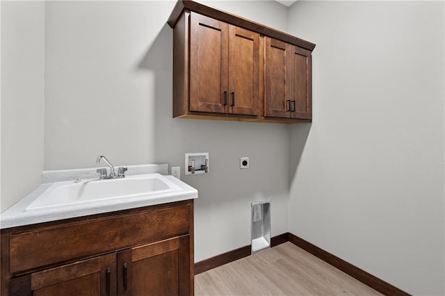 laundry area featuring hookup for a washing machine, hookup for an electric dryer, a sink, baseboards, and cabinet space