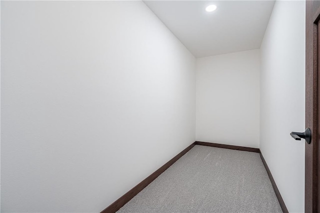 spare room with light colored carpet and baseboards