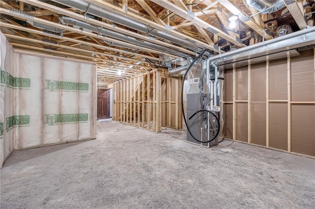 unfinished basement featuring heating unit