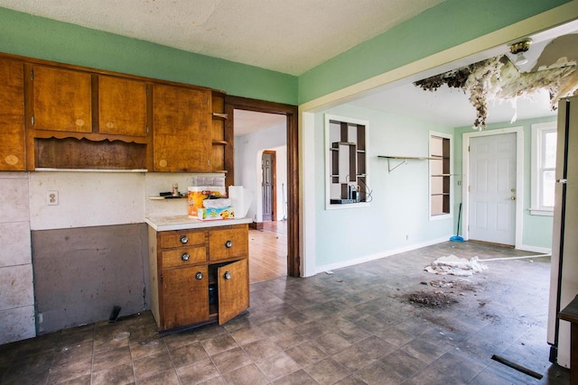 kitchen with dark tile patterned flooring and a textured ceiling