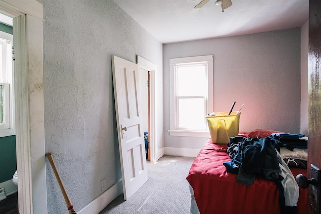 bedroom with light colored carpet and ceiling fan