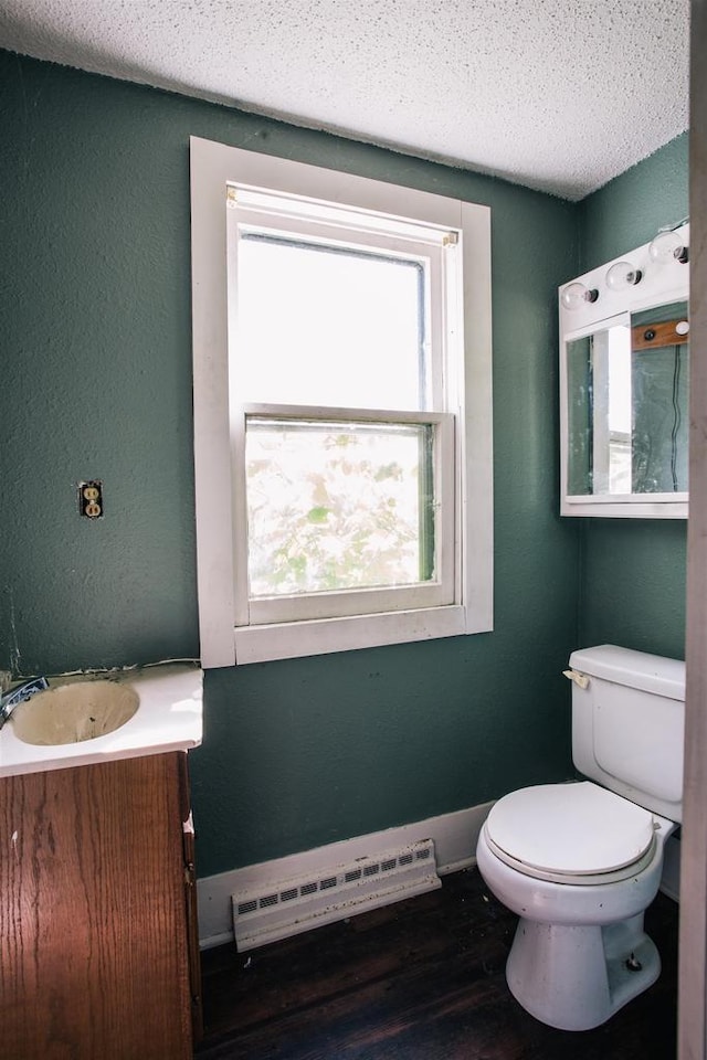 bathroom featuring a textured ceiling, vanity, toilet, and wood-type flooring