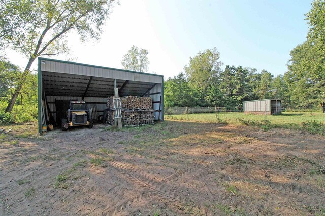 7750 Pine Rd, Arena, WI 53503 - exterior space featuring an outbuilding, a carport, and fence