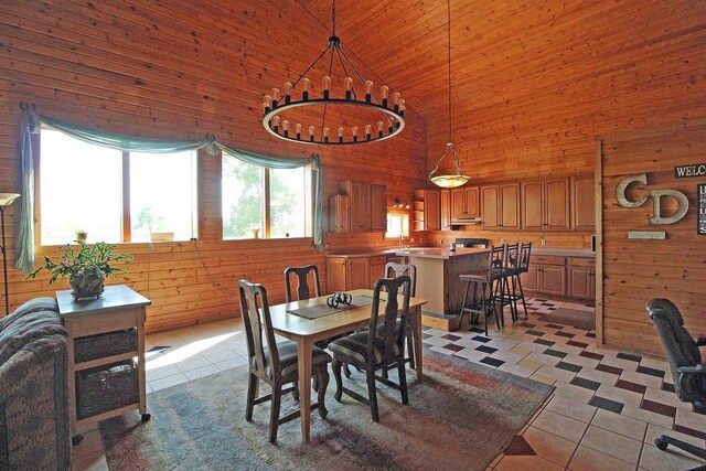 7750 Pine Rd, Arena, WI 53503 - dining space with high vaulted ceiling, wooden walls, wood ceiling, and light tile patterned floors