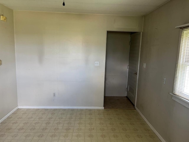 empty room with plenty of natural light and light tile patterned flooring