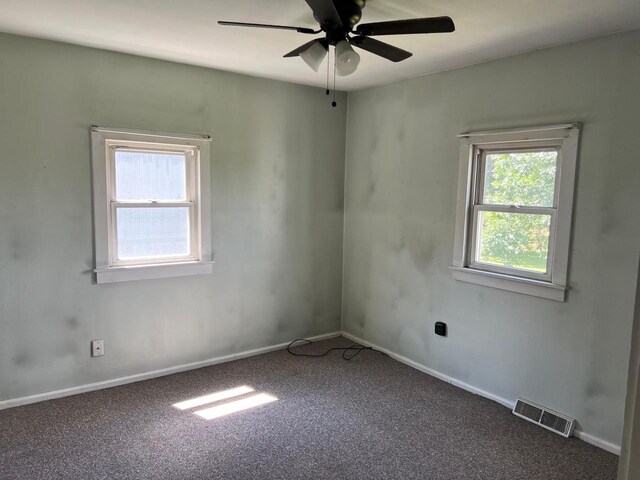 empty room featuring ceiling fan and dark hardwood / wood-style flooring