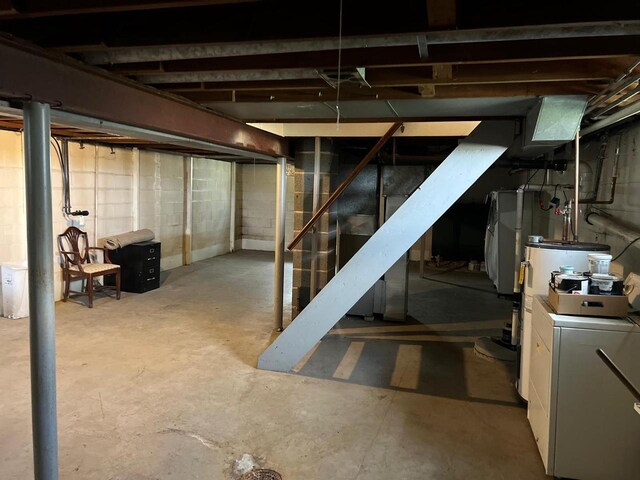 basement featuring washer / clothes dryer and water heater