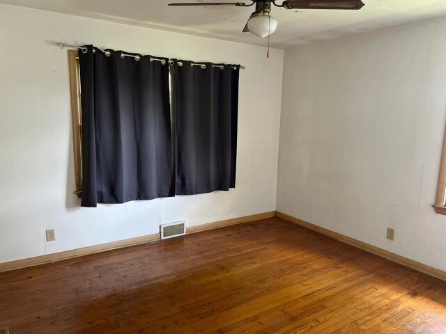 unfurnished room with ceiling fan and hardwood / wood-style flooring