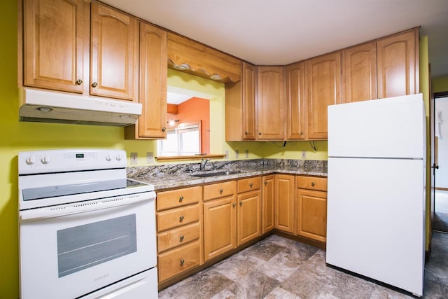 kitchen with dark stone countertops, white appliances, sink, and tile patterned flooring