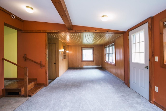 entrance foyer with vaulted ceiling, baseboard heating, wood walls, and carpet