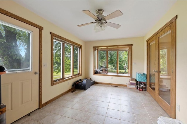 sunroom with ceiling fan, visible vents, and french doors