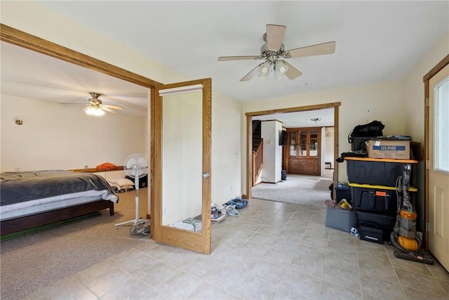 bedroom with a ceiling fan and light colored carpet