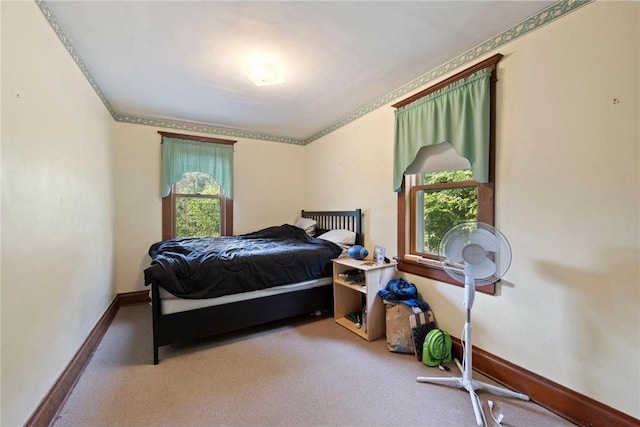 bedroom with carpet, baseboards, and crown molding