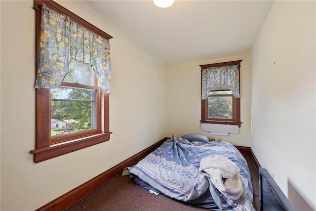 bedroom featuring carpet floors and baseboards