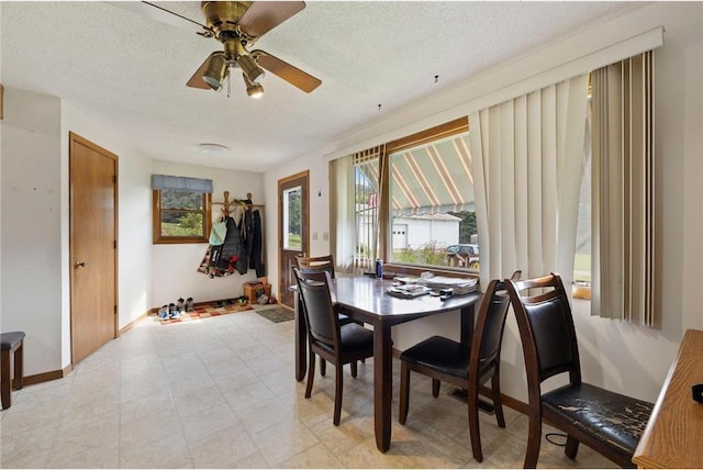 dining space featuring a textured ceiling and ceiling fan