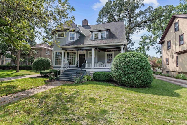 victorian home featuring a front lawn and a porch