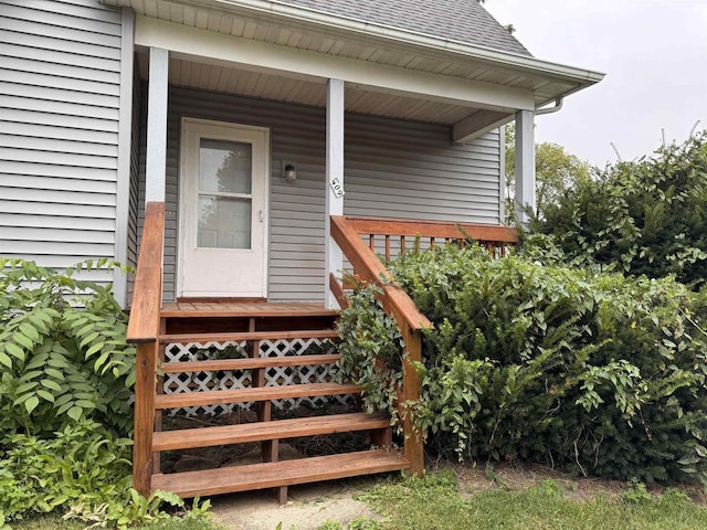 property entrance with roof with shingles