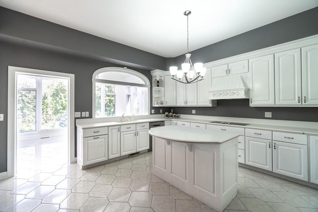 kitchen with light countertops, custom exhaust hood, and white cabinetry