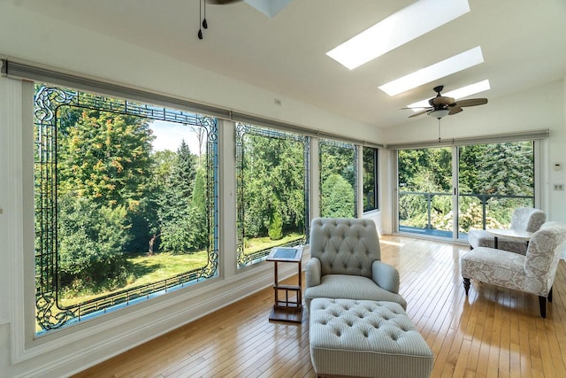 sunroom / solarium with ceiling fan and lofted ceiling with skylight