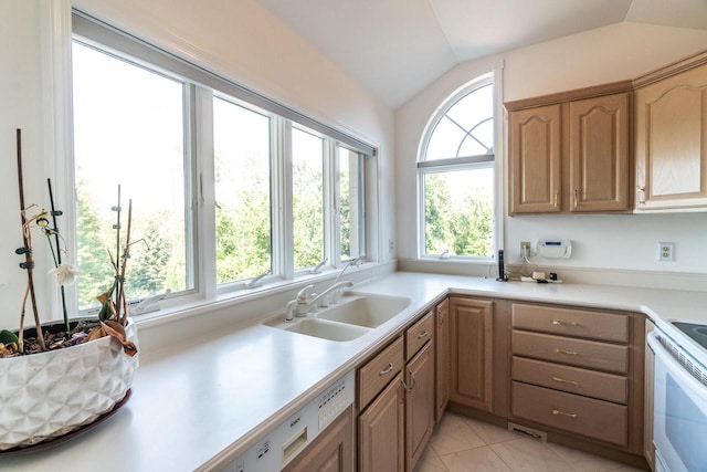 kitchen featuring white electric range, vaulted ceiling, light countertops, and a sink