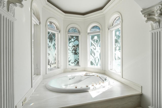 full bathroom with a healthy amount of sunlight, ornamental molding, and a whirlpool tub