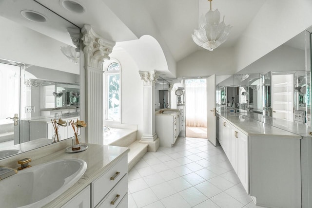 full bathroom with a wealth of natural light, lofted ceiling, a sink, and decorative columns