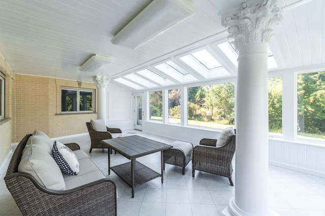 sunroom with ornate columns and vaulted ceiling