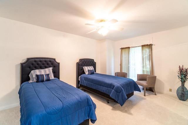 bedroom with baseboards, a ceiling fan, and light colored carpet