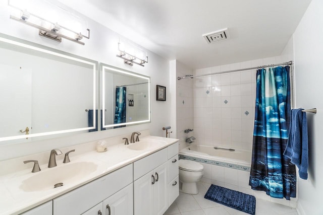 full bathroom with tiled shower / bath, double vanity, a sink, and visible vents