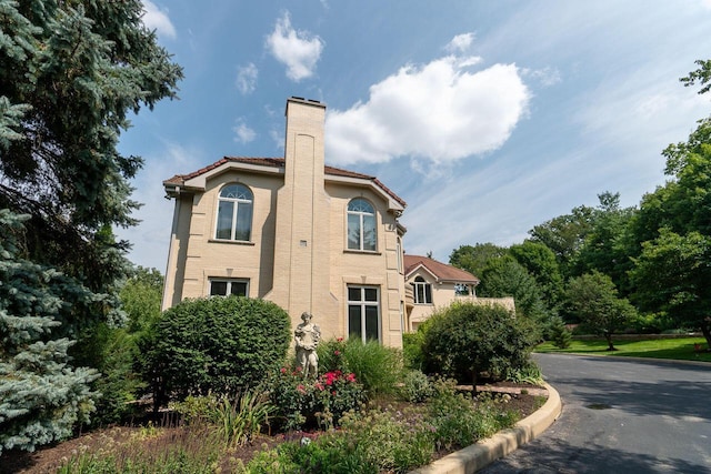 view of property exterior with a chimney