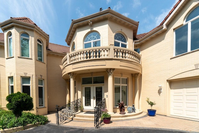 exterior space with brick siding and a balcony