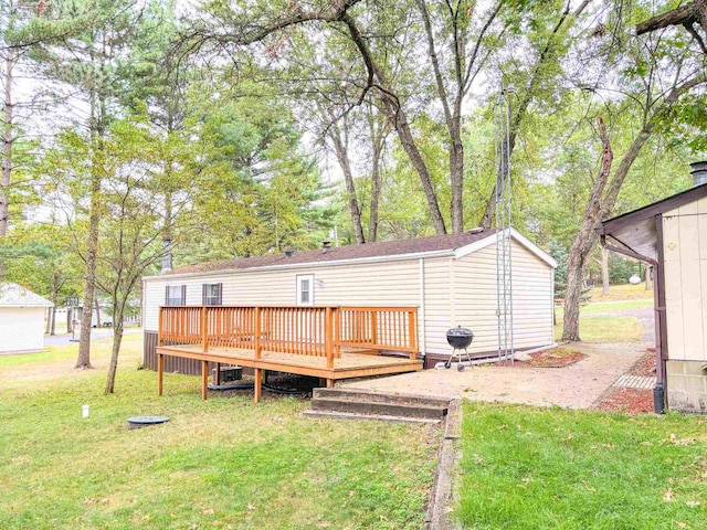 back of property featuring a lawn, a wooden deck, and cooling unit